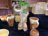 a table with mugs and pots on it