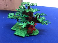 a lego tree on a blue surface