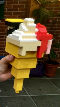 a person holding a lego ice cream cone